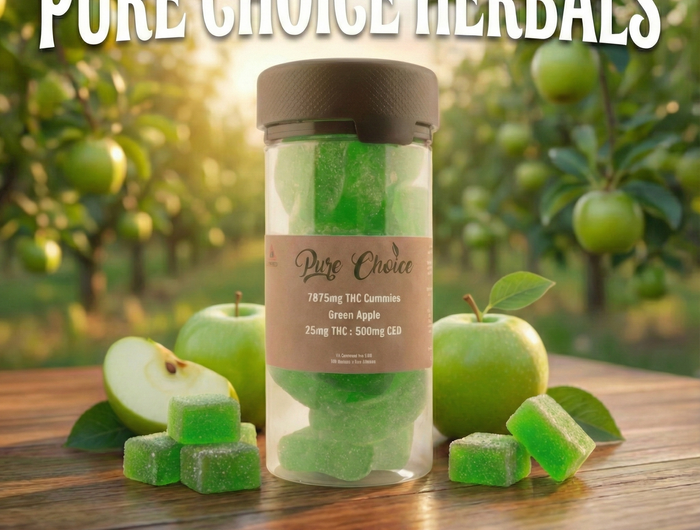 Jar of green apple-flavored edibles with 'Pure Choice Herbals' branding, surrounded by apples in a garden setting.